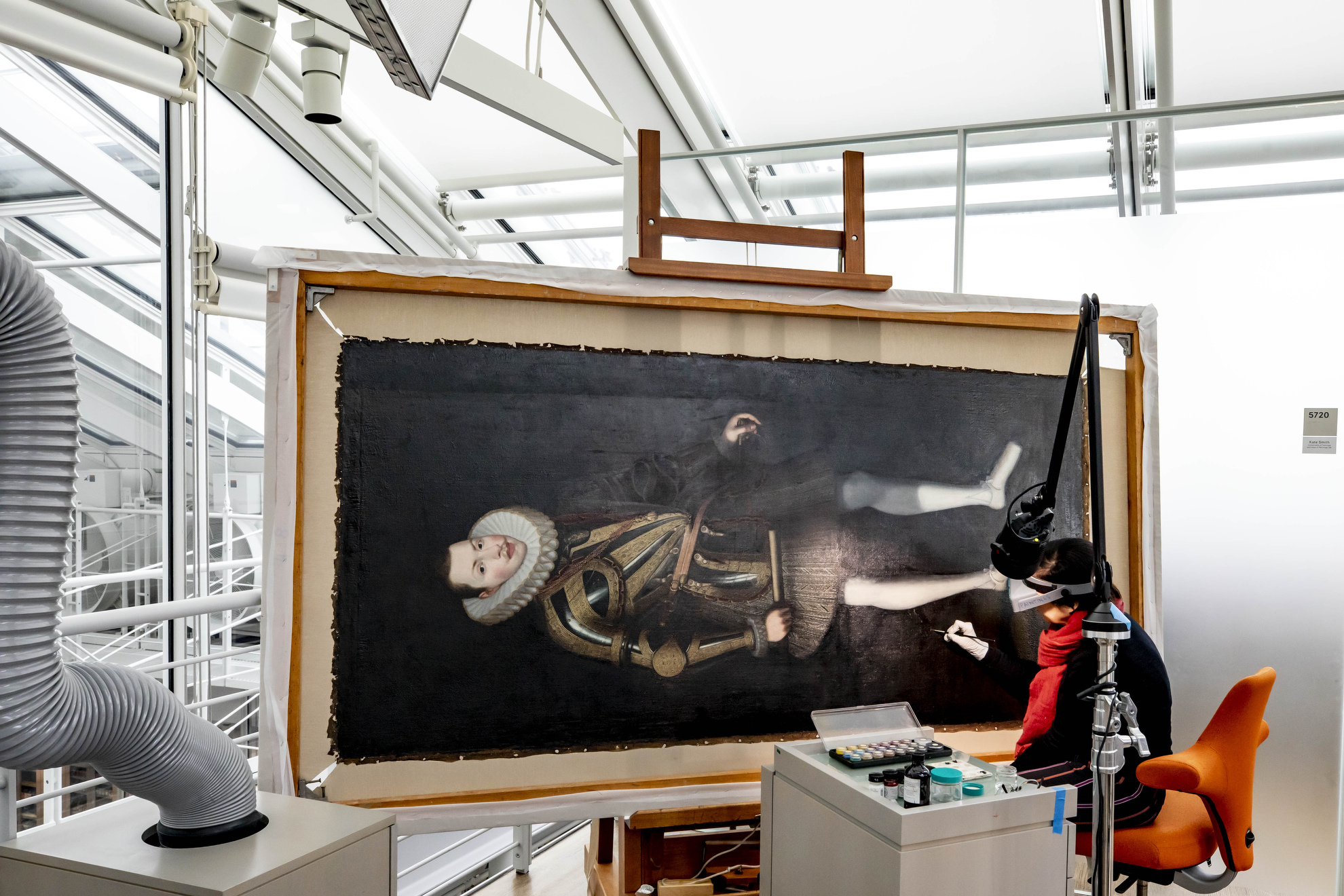 Cristina Morilla, Associate Paintings Conservator conserves a portrait of King Philip of Spain at Harvard Art Museum.