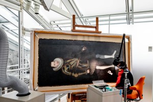 Cristina Morilla, Associate Paintings Conservator conserves a portrait of King Philip of Spain at Harvard Art Museum.
