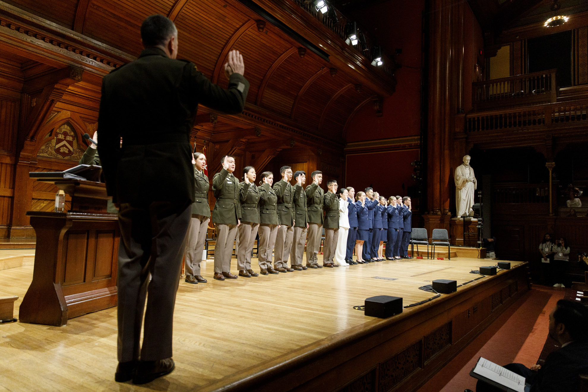 ROTC members take the oath of office during Harvard’s ROTC commissioning ceremony for the Class of 2025, in Sanders Theatre, 