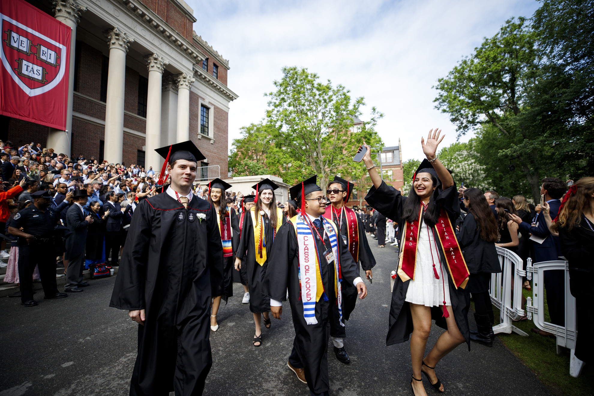 Graduates walk into Tercentenary Theatre.