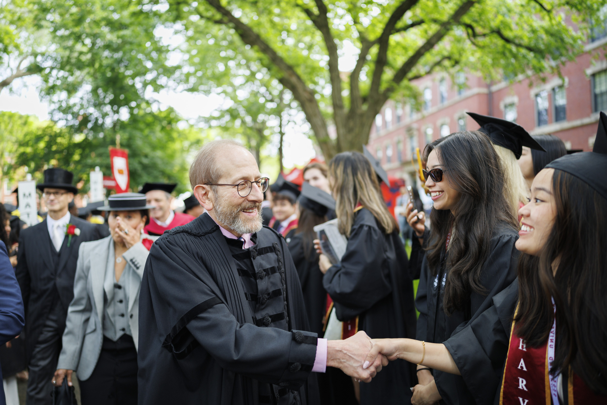Harvard President Alan Garber (center) processes into the ceremony.