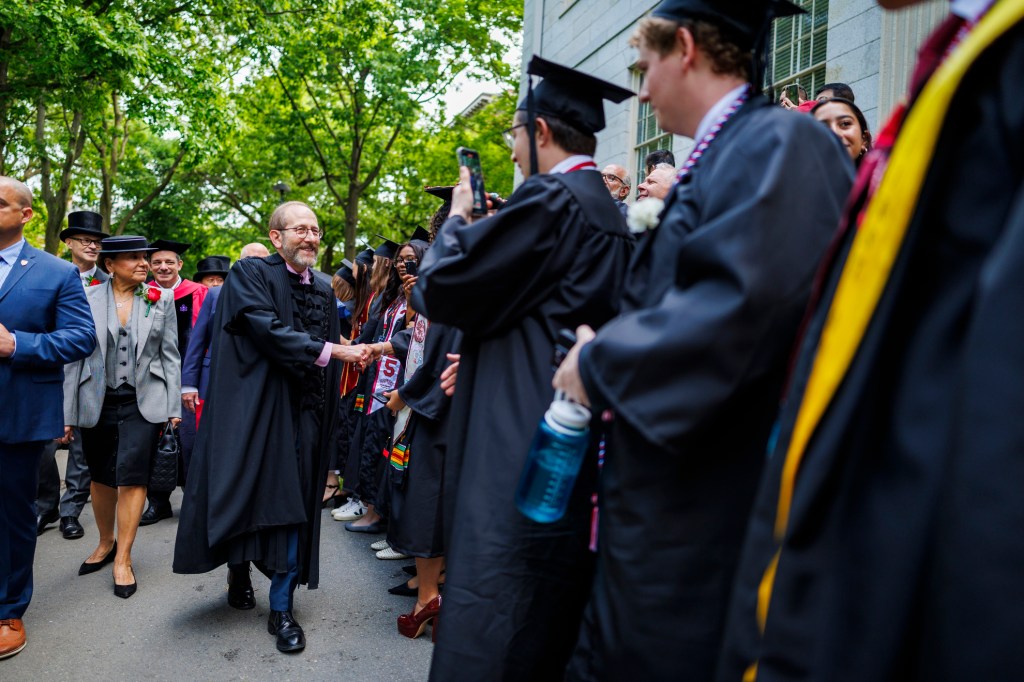 President Alan Garber (center) processes Tercentenary Theatre.