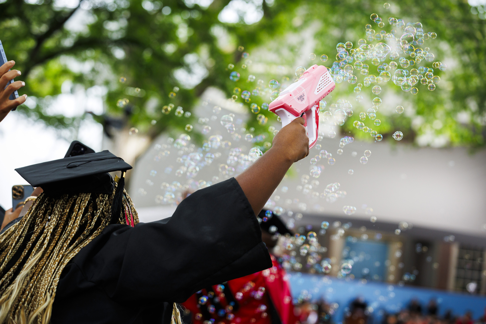 Tiffany Onyeiwu (pictured) blows bubbles during the ceremony.