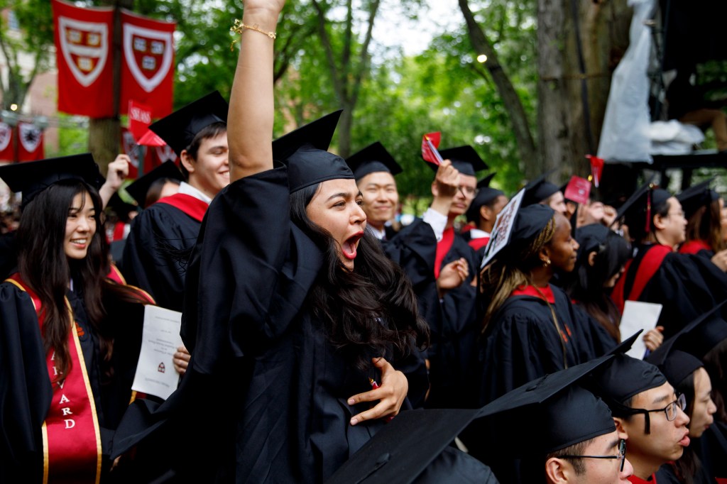 Maryam Hussaini (center) cheers as her group of graduate students.