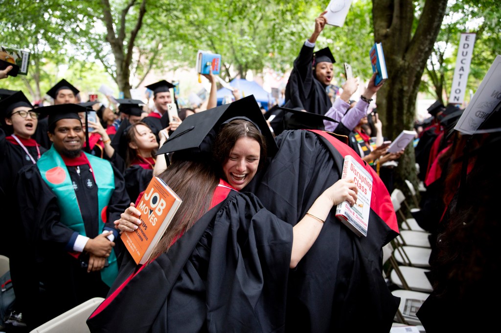 Makena Tenpenny (center) embraces her fellow Harvard Graduate School of Education classmates.