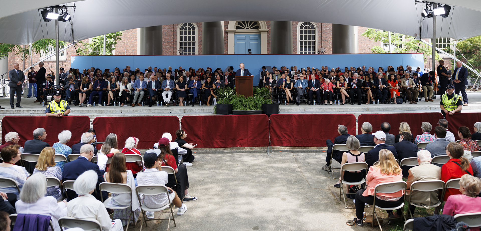 Harvard President Alan Garber speaking on stage during Alumni Day.