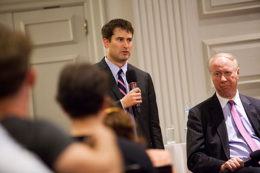In 2013, Seth Moulton (standing) attended a panel discussion moderated by David Gergen.