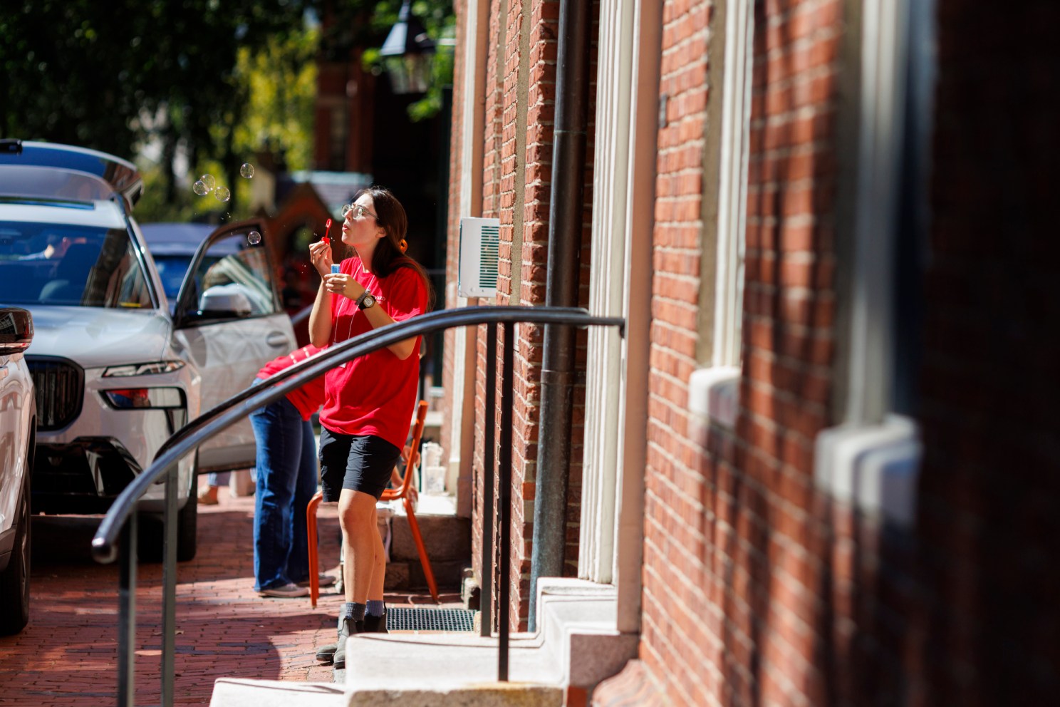 Harvard senior Lexi Triantis blows bubbles outside Hollis Hall.