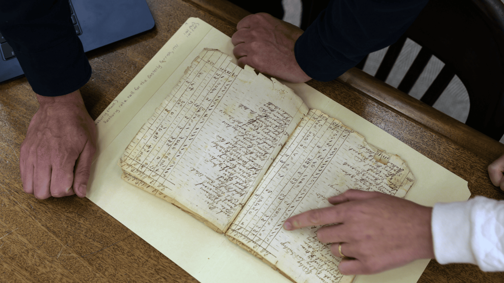 Gabriel Raeburn and Christine Bachman-Sanders reviews documents.