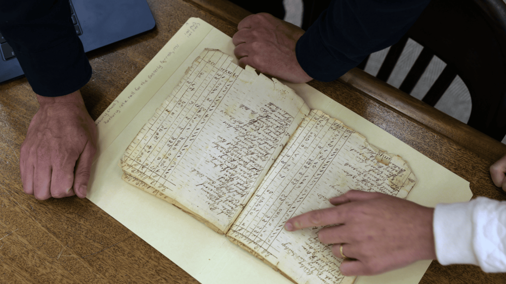 Gabriel Raeburn reviews documents with fellow American Ancestors researcher Christine Bachman-Sanders.