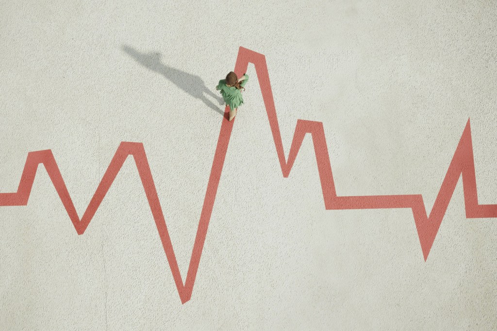Woman walking on pulse trace shaped zigzag line.