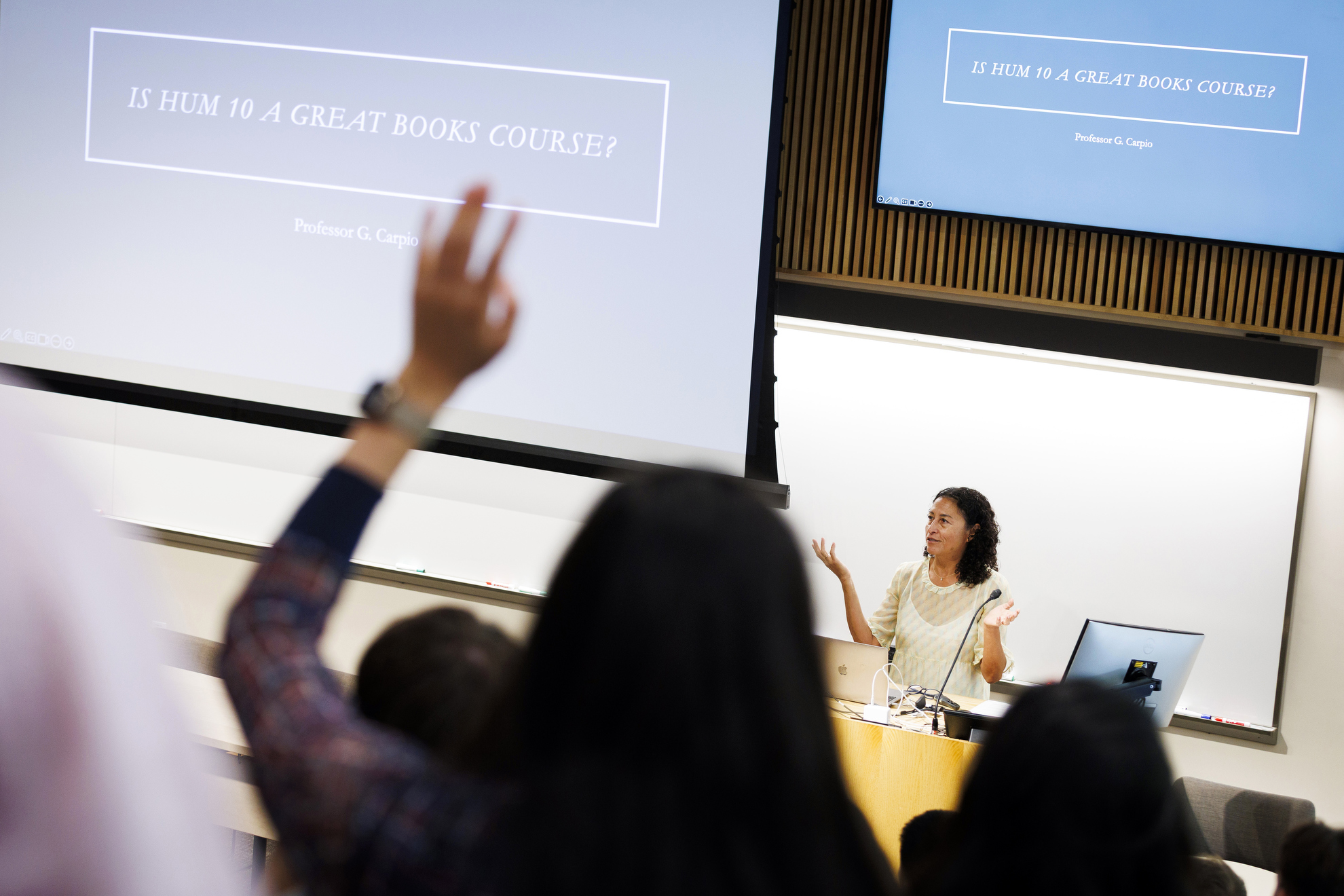 Glenda Carpio is pictured at the podium giving introductory remarks.