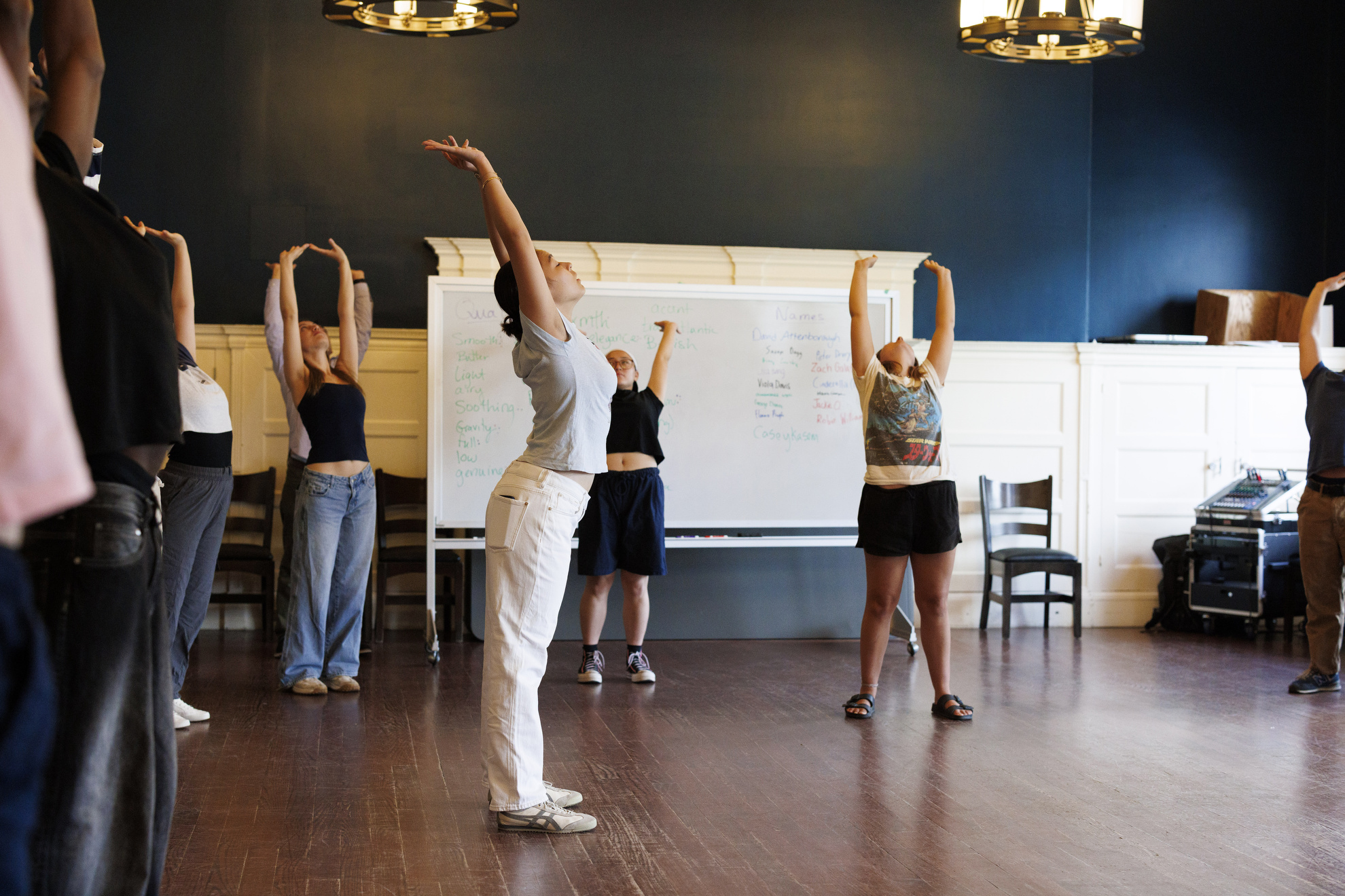 Students perform body movements in TDM 119: Introduction to Voice and Speech, in Farkas Hall.