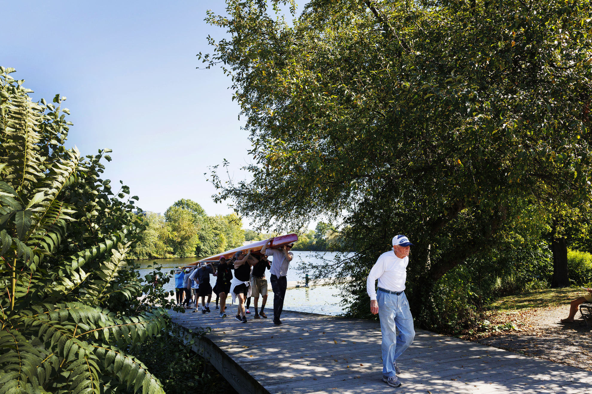 Bill Becklean, the 89-year-old coxswain for the Octo Eight, leads the boat to the boat house after practice.