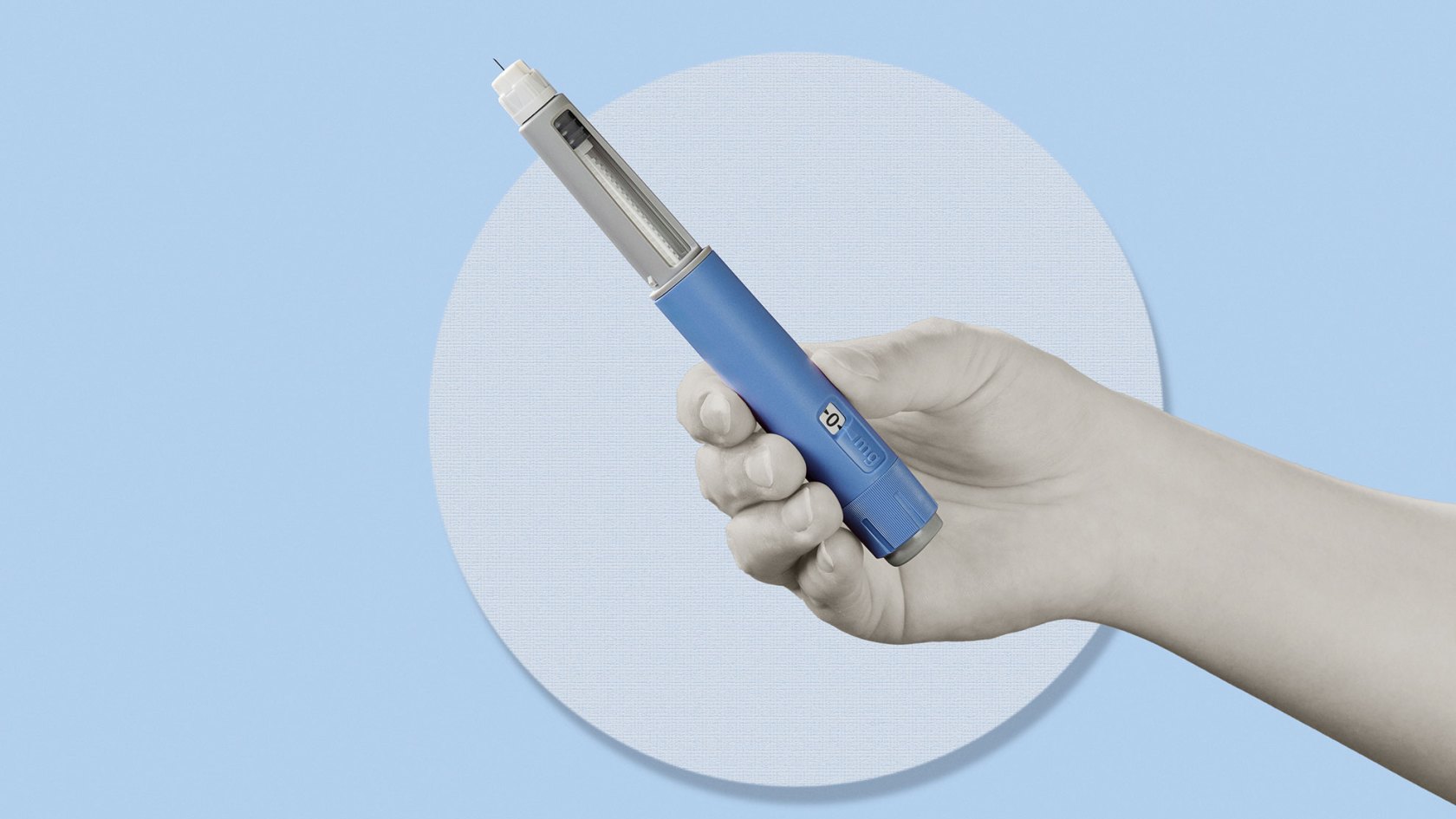 Hand holding semaglutide injection pen.