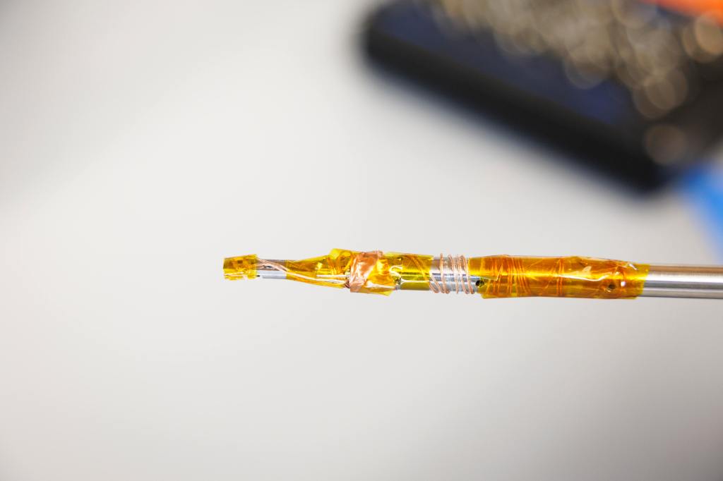 A close up of an electron microscope specimen holder.