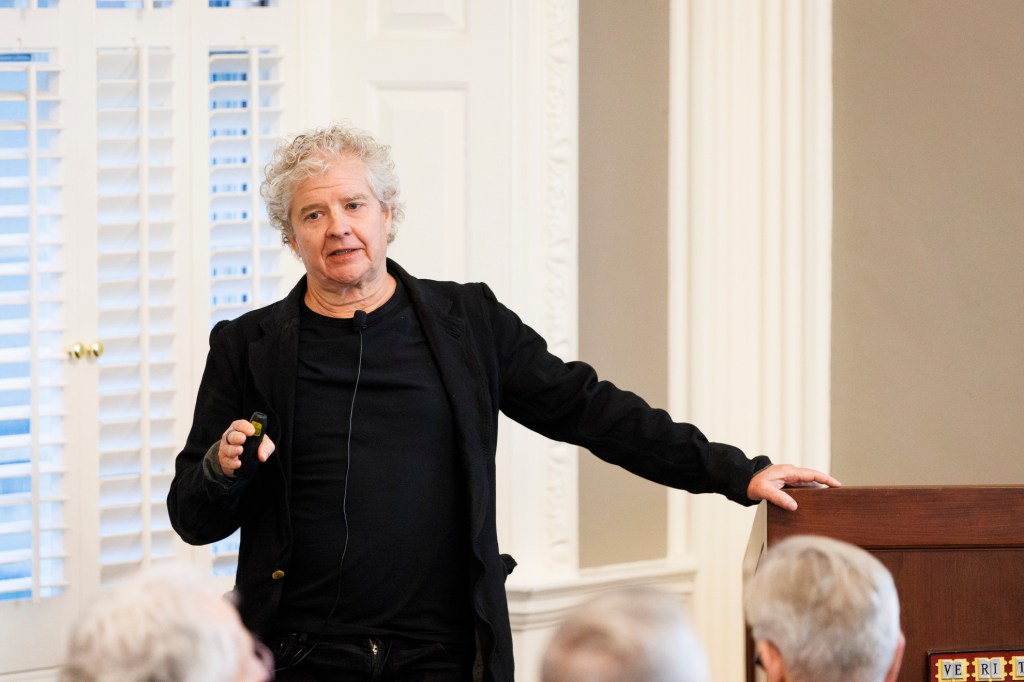 Sean Reardon speaking to audience member