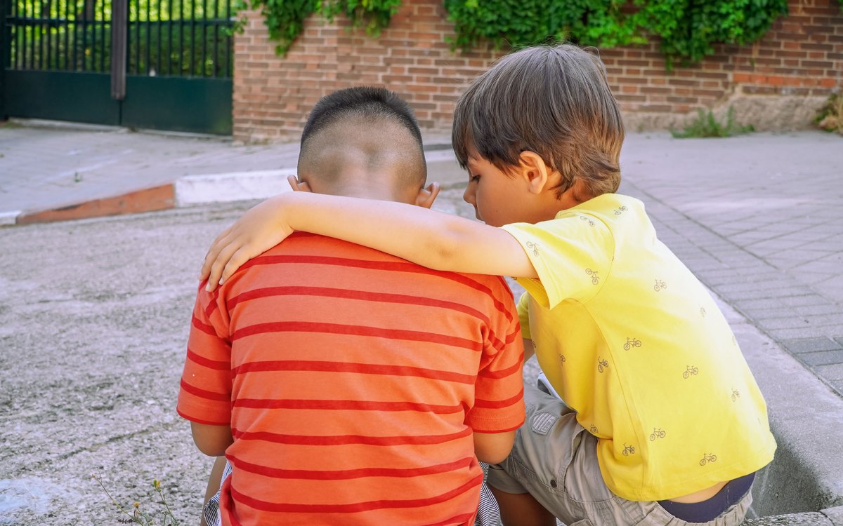 LIttle boy comforting his friend.