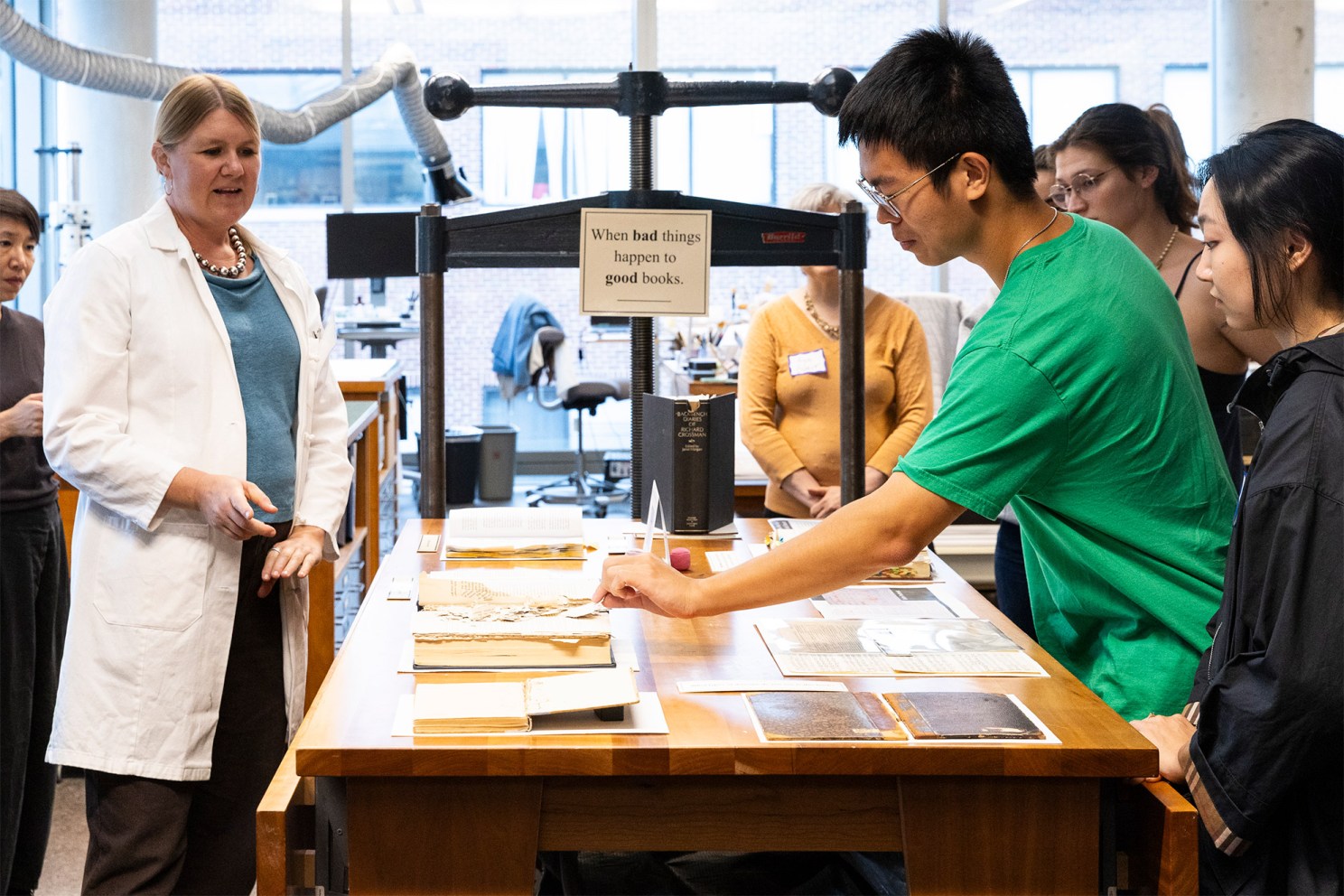 Students examine books from a teaching collection.