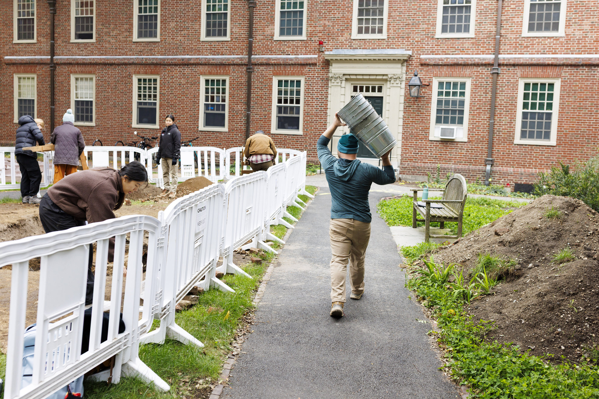 Student David Broussard carries buckets back to storage at the conclusion of a dig session.