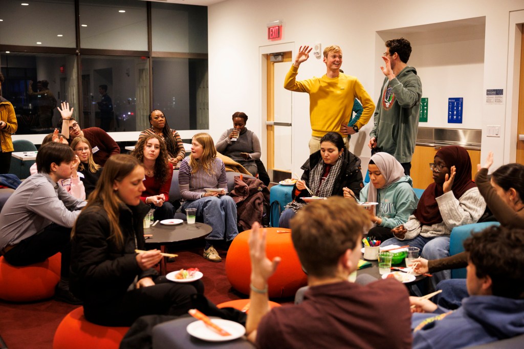 Participants raise their hands during a portion of the event. 