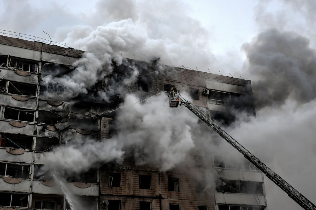 A firefighter uses an aerial ladder to suppress a fire in an apartment block hit by a Russian guided aerial bomb in Zaporizhzhia, Ukraine, on December 17, 2025.