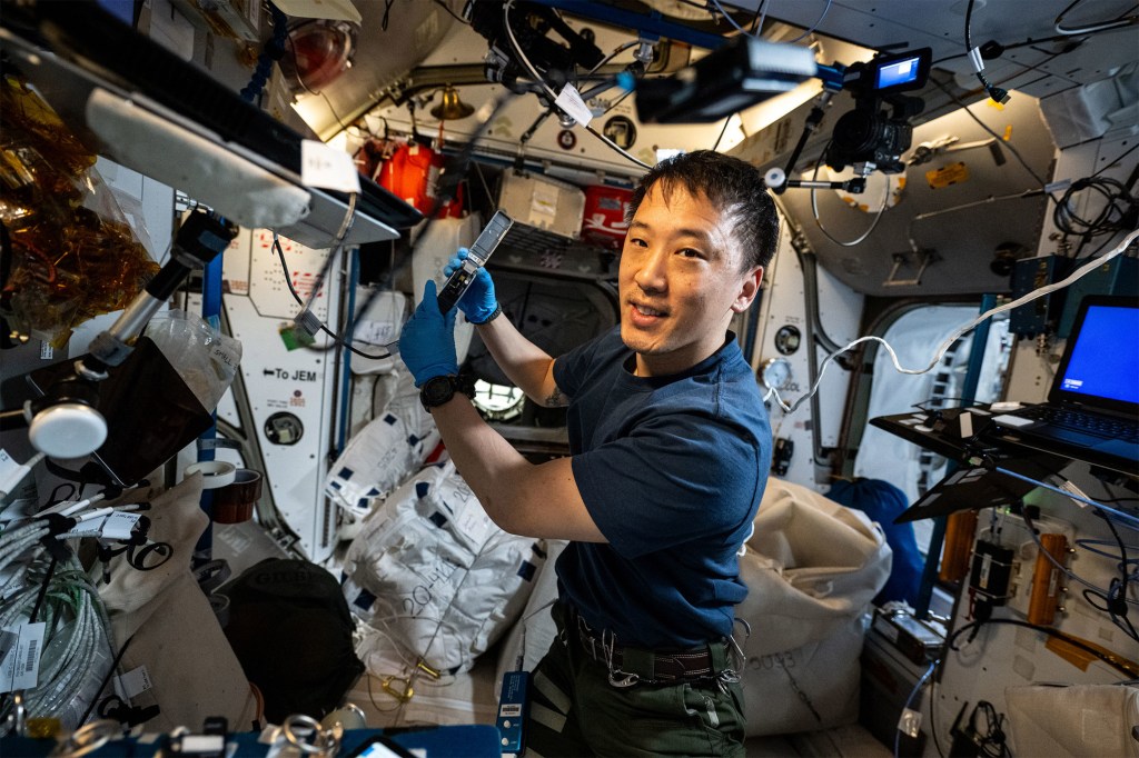 NASA astronaut and Expedition 73 Flight Engineer Jonny Kim waves for a portrait.