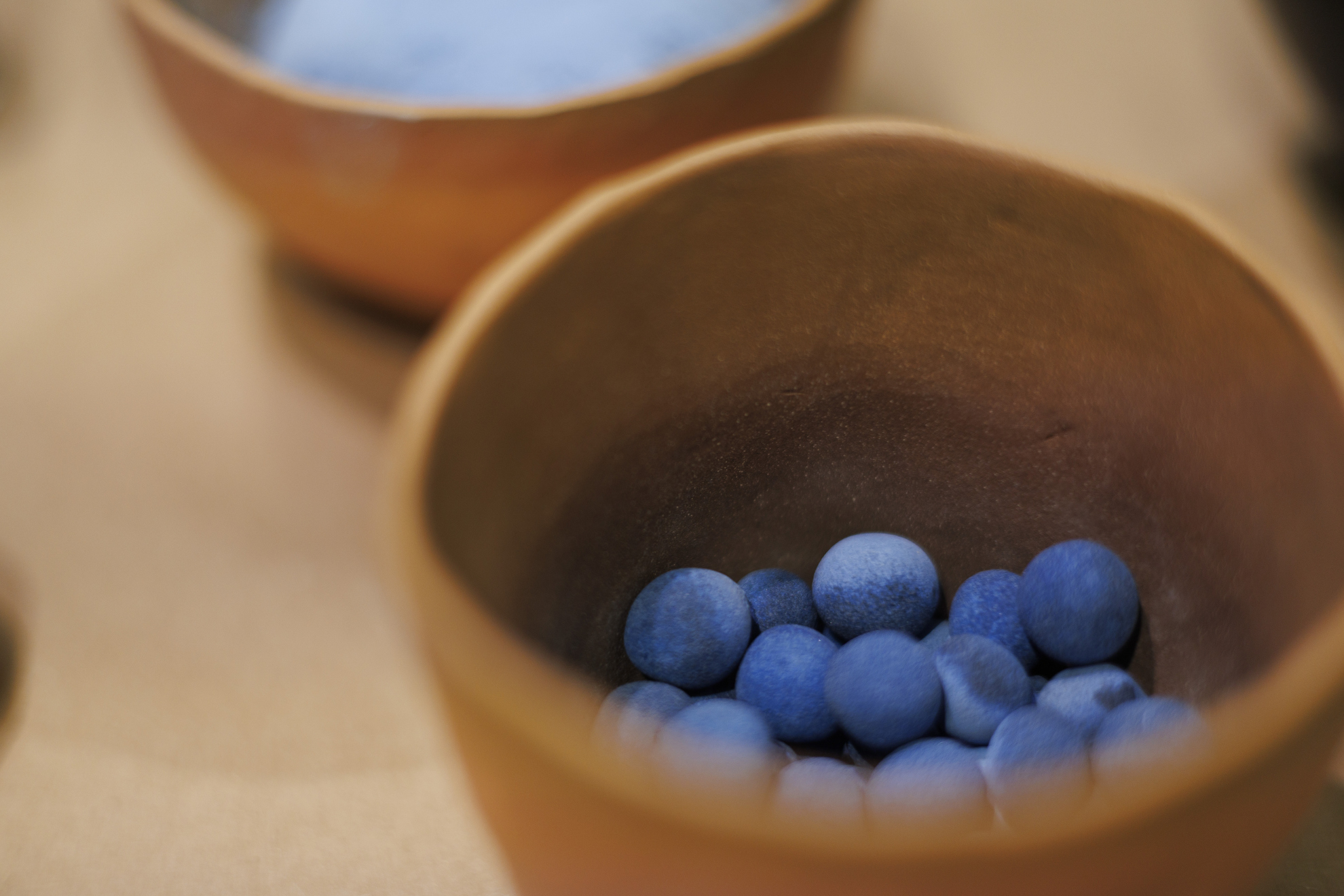 A pot of Egyptian Blue pigment pellets.